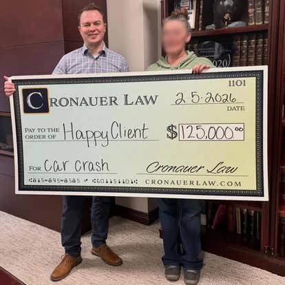 Cronauer Law client receiving settlement check