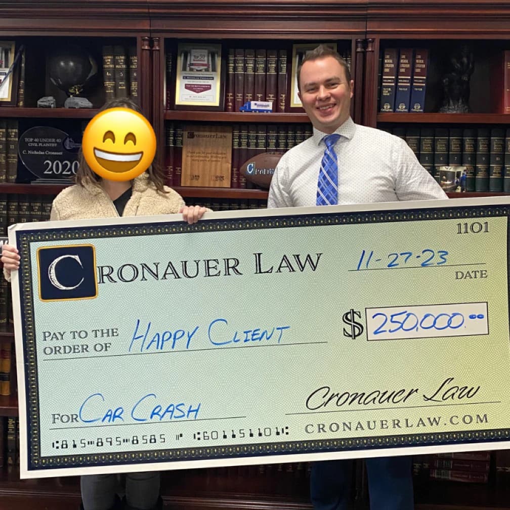 Cronauer Law client receiving settlement check