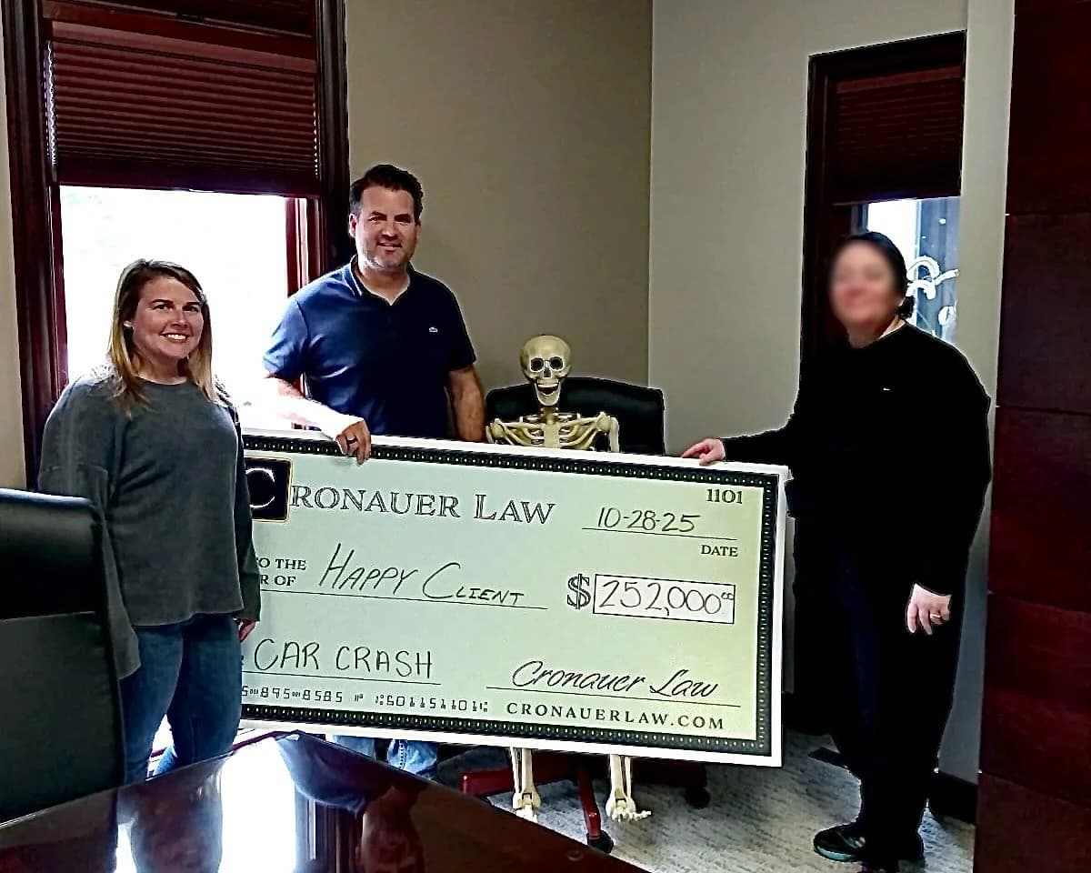 Cronauer Law client receiving settlement check