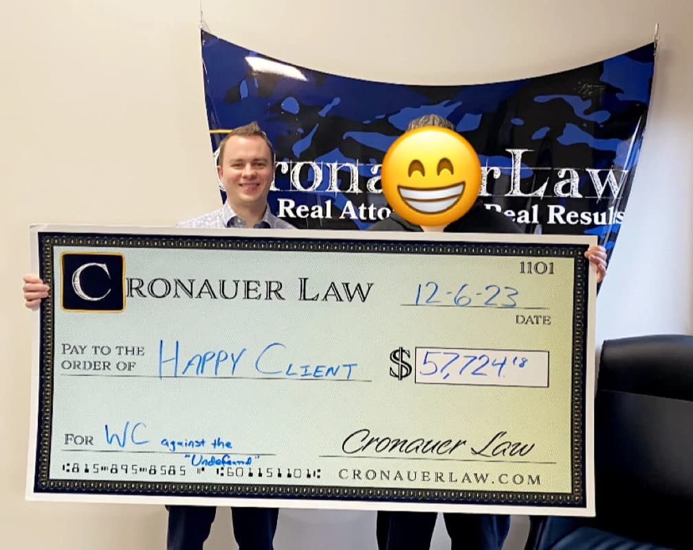 Cronauer Law client receiving settlement check