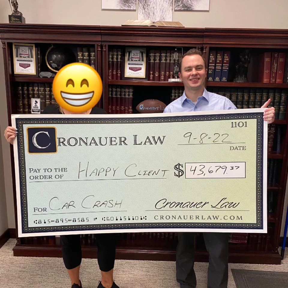 Cronauer Law client receiving settlement check